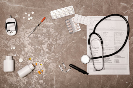 Flat lay composition with form for laboratory test, digital glucometer, medicine and stethoscope on...