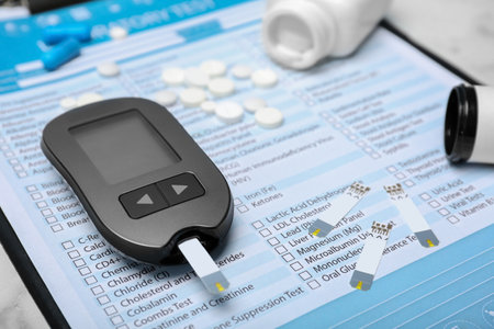 Digital glucometer and medicine on form for laboratory test. Diabetes conceptの写真素材