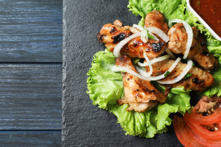 Slate plate with tasty shish kebab and sauce, top viewの写真素材