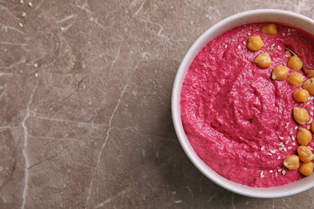 Bowl of fresh beet hummus on gray background, top viewの写真素材