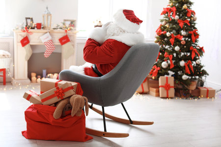 Authentic Santa Claus with bag of gifts indoorsの写真素材