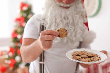 Authentic Santa Claus with plate of cookies indoorsの写真素材