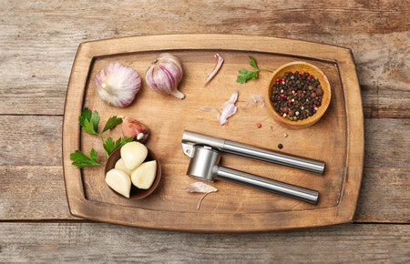 Flat lay composition with garlic press on wooden tableの写真素材