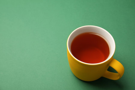 Cup of black tea on color backgroundの写真素材