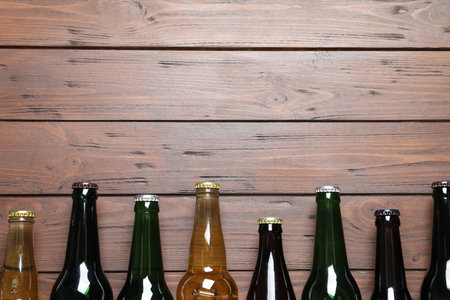 Bottles with different types of beer on wooden backgroundの写真素材