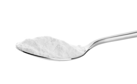 Spoon with baking soda on white backgroundの写真素材