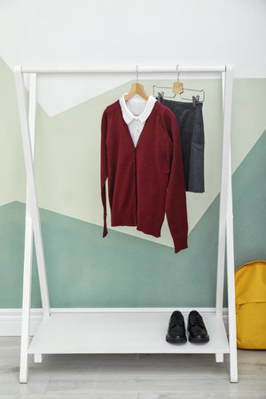 School uniform for girl on rack near color wallの写真素材