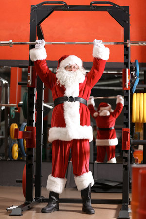 Authentic Santa Claus training in modern gymの写真素材