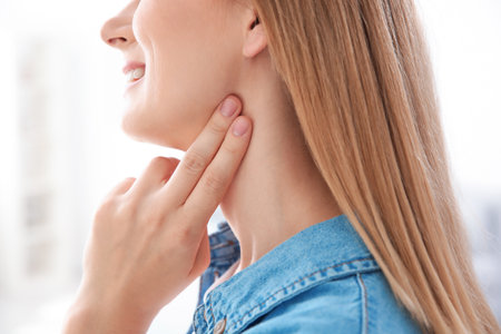 Young woman checking pulse on blurred background