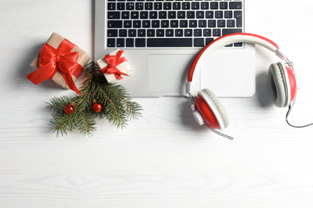 Flat lay composition with decorations, laptop and headphones on wooden background. christmas music conceptの写真素材