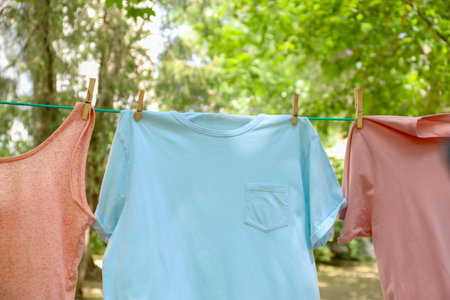 Laundry line with clothes outdoors on sunny dayの写真素材