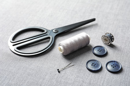 Set of tailoring accessories on gray fabricの写真素材