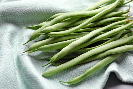 Pile of fresh green beans on towelの写真素材