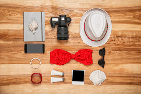 Flat lay composition with camera and beach objects on wooden backgroundの写真素材