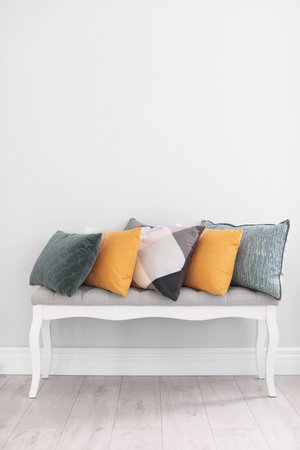 Different pillows on couch near light wall in roomの写真素材