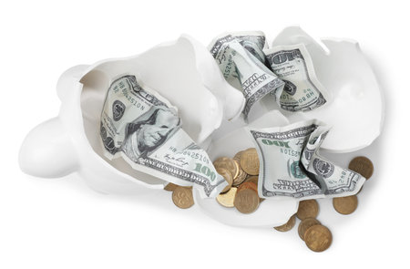 Broken piggy bank with coins and banknotes on white background. money savingの写真素材