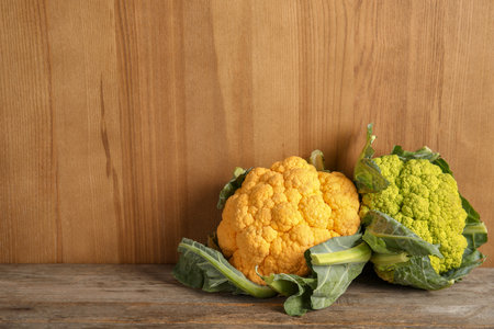 Colorful cauliflower cabbages on wooden table. Health foodの写真素材