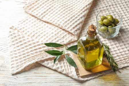 Bottle with fresh olive oil on tableの写真素材