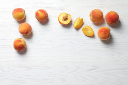 Fresh sweet peaches on wooden table, top viewの写真素材