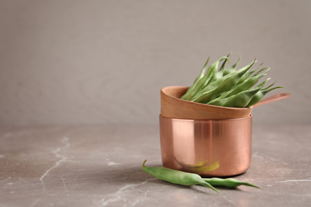 Dishes with fresh green beans on tableの写真素材
