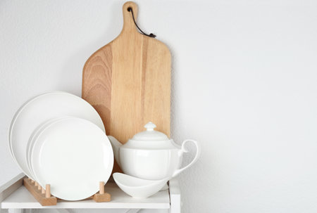 Different clean tableware on shelf in kitchenの写真素材