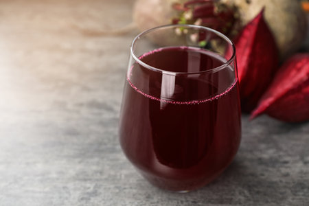 Glass with fresh healthy beet juice on tableの写真素材