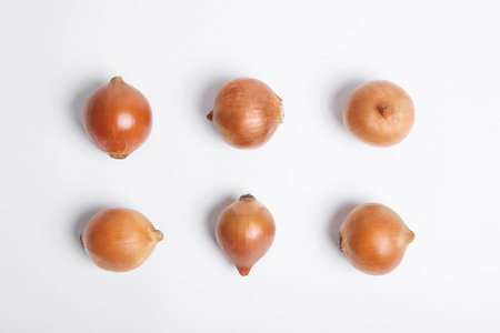 Beautiful composition with ripe onions on white backgroundの写真素材
