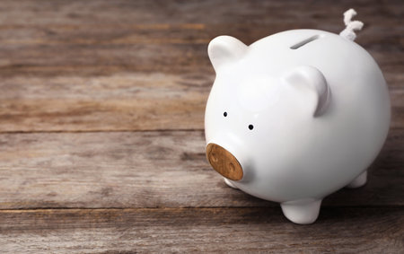 White piggy bank on wooden table. money savingの写真素材