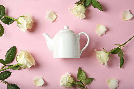 Flat lay composition with teapot and roses on color backgroundの写真素材