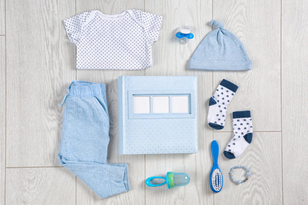 Flat lay composition with stylish child clothes and accessories on wooden backgroundの写真素材