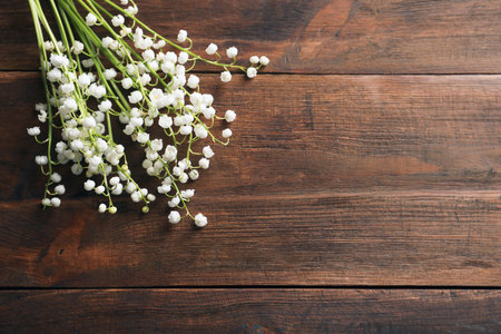 Fresh spring flowers on wooden background, top viewの写真素材