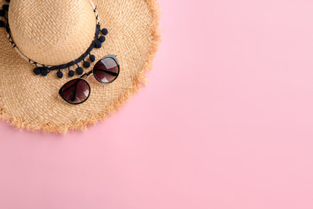 Stylish hat and sunglasses on color background, top viewの写真素材