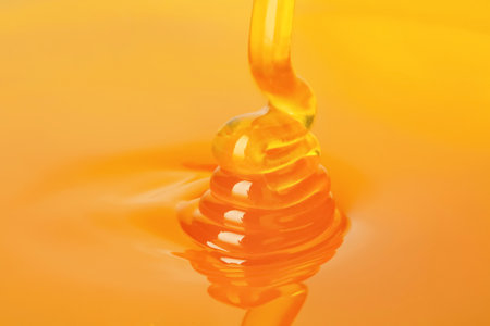 Pouring fresh sweet honey, closeupの写真素材