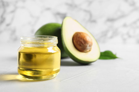 Jar with avocado oil on tableの写真素材