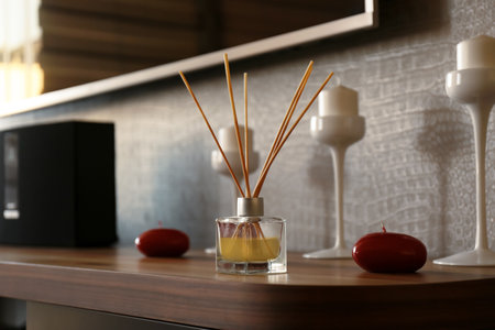 Reed air freshener on wooden table indoorsの写真素材
