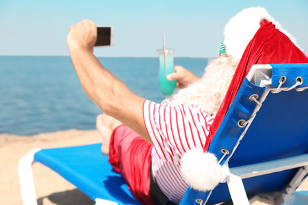 Authentic Santa Claus taking selfie at resortの写真素材