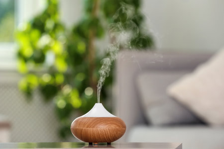 Aroma oil diffuser lamp on table against blurred backgroundの写真素材