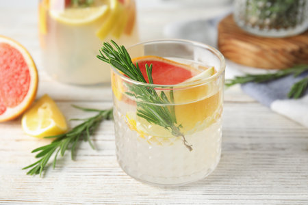 Refreshing grapefruit cocktail with rosemary on tableの写真素材