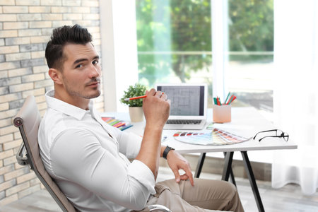 Portrait of handsome young man in officeの写真素材