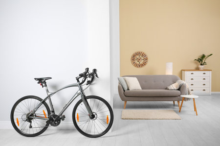 Modern apartment interior with bicycle near wall. Space for textの写真素材
