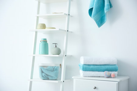Room interior with clean towels and toiletriesの写真素材
