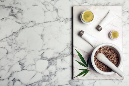 Flat lay composition with hemp lotion and space for text on marble backgroundの写真素材