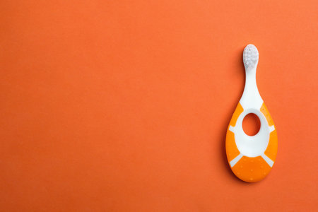 Manual toothbrush for child on color background, top view with space for textの写真素材
