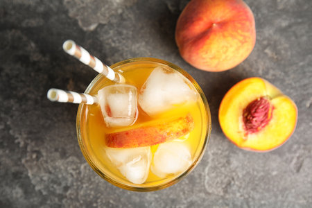 Tasty peach cocktail in glass on table, top view. Refreshing drinksの写真素材
