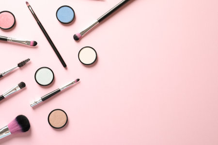 Flat lay composition with products for decorative makeup on pastel pink backgroundの写真素材
