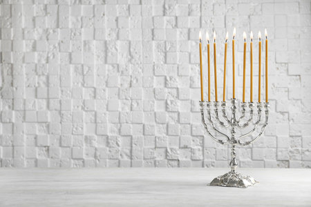 Hanukkah menorah on table against white backgroundの写真素材