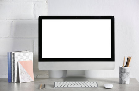 Computer with blank monitor on office table. Mock up designの写真素材