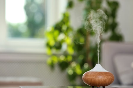 Aroma oil diffuser lamp on table against blurred backgroundの写真素材