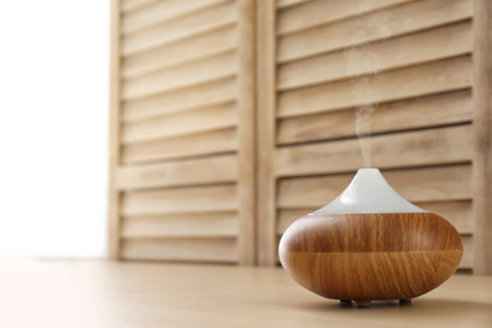 Modern aroma lamp and space for text on blurred backgroundの写真素材