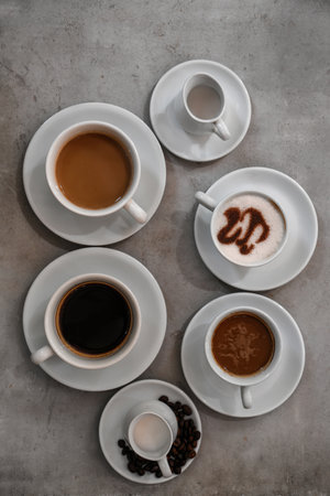 Cups of fresh aromatic coffee on gray background, top viewの写真素材